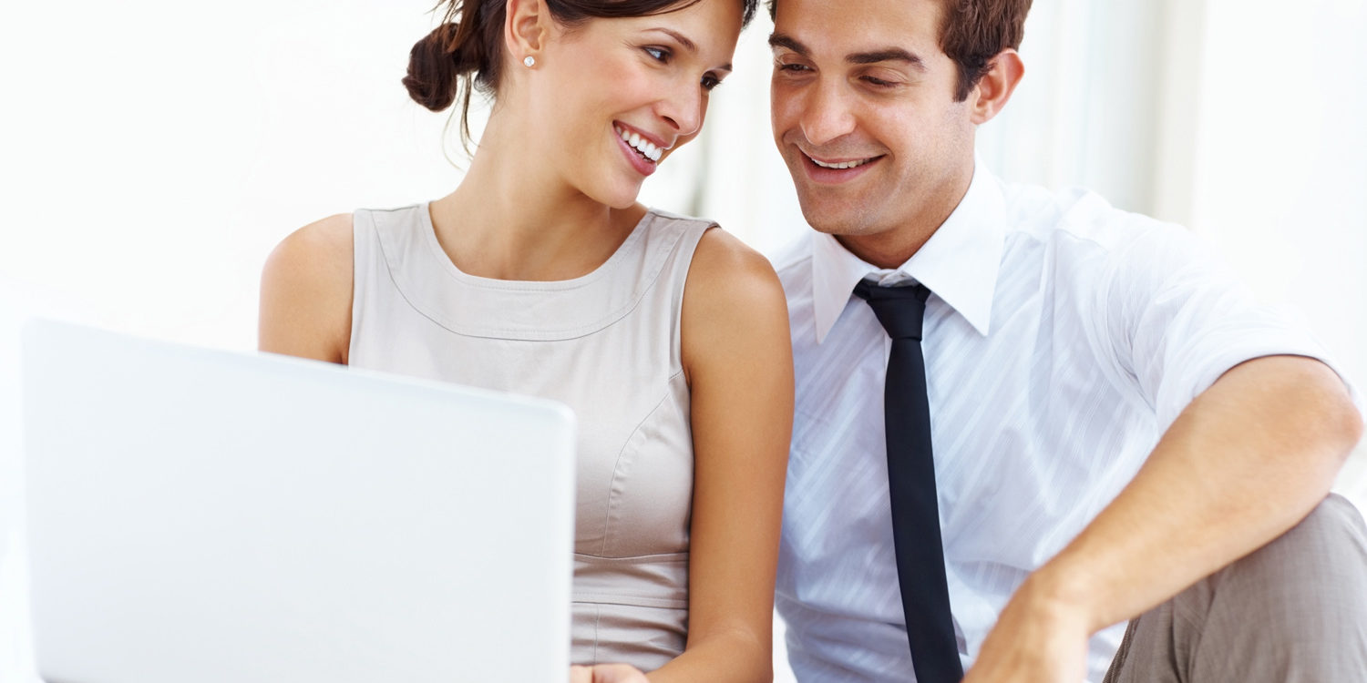 Young business couple working on laptop
