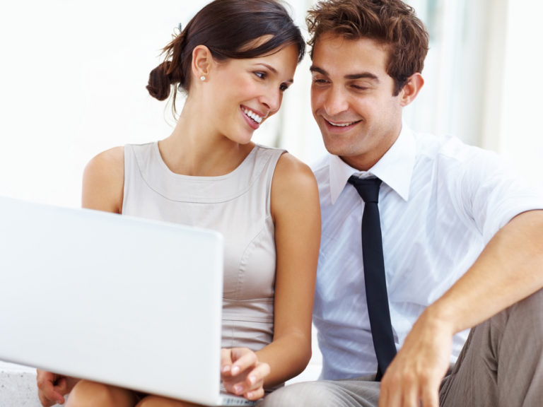 Young business couple working on laptop